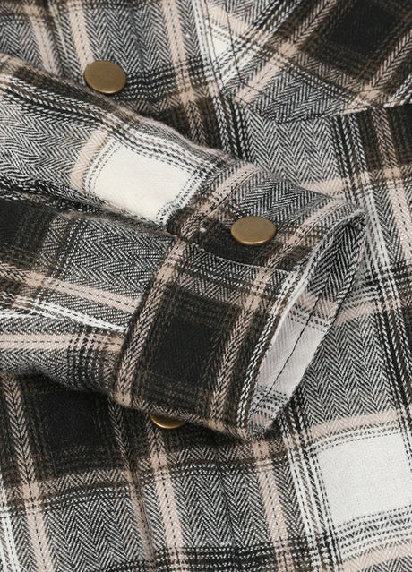 Close-up of cuff with button on kids white plaid flannel jacket 