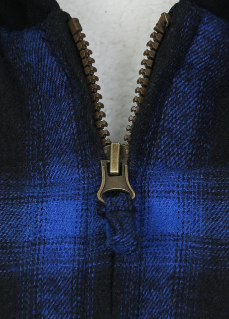 Detail of smooth zipper on kids blue black hooded plaid flannel jacket