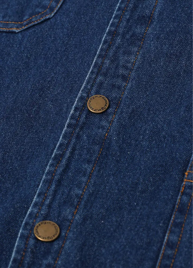 Close-up of the snap button of blue men's denim shacket with flannel lining