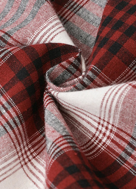 Detailed view of cozy fabric on kid's wine sleeveless plaid vest 