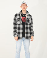 A boy who wears a checkered grey flannel shacket