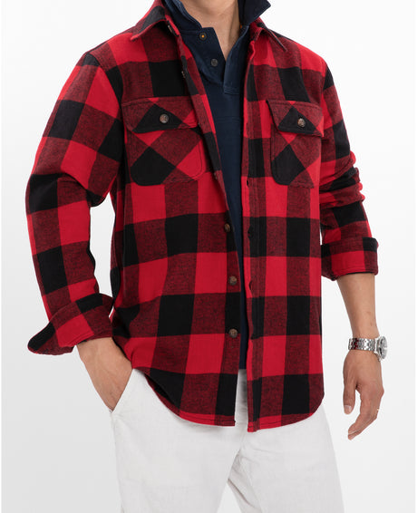 A man with one hand in his pockets in a red buffalo plaid stalwart cotton flannel shirt for men